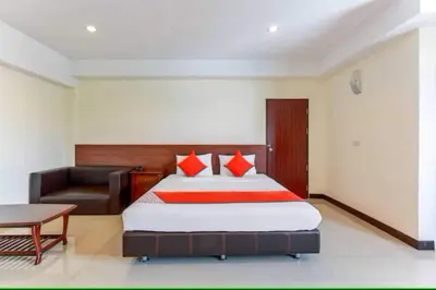 a hotel room with a bed and a couch at Dancenter VResotel in Bangkok