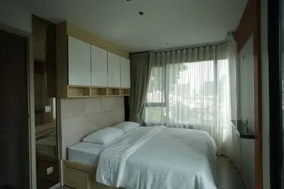 a bedroom with a white bed and a window at Life Ladprao 2 bedrooms condo in Bangkok