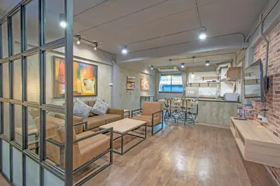 a living room with a couch and a table at Private apartment in Huaikwang in Bangkok