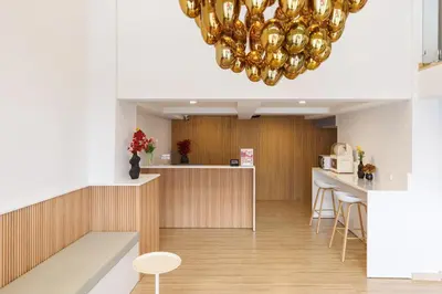 a large chandelier in a room with a counter at Takka Hotel - Bearing in Bangna
