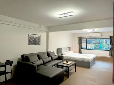 a living room with a couch and a bed at Berlin Haus in Nonthaburi