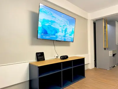 a flat screen tv hanging on a wall at Berlin Haus in Nonthaburi