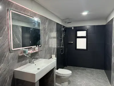 a bathroom with a sink and a toilet and a mirror at Berlin Haus in Nonthaburi
