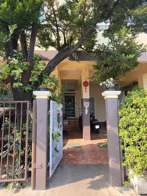 a house with a gate and a tree at Sukkasame Apartment At Ngamwongwan in Ban Bang Khen (1)