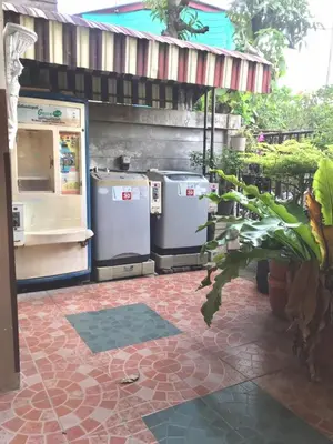 a kitchen with three refrigerators sitting under a building at Sukkasame Apartment At Ngamwongwan in Ban Bang Khen (1)