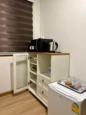 a kitchen with a microwave on top of a counter at Sukkasame Apartment At Ngamwongwan in Ban Bang Khen (1)