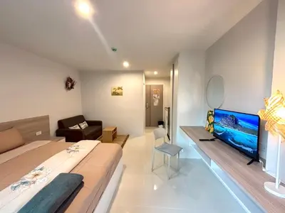 a bedroom with a bed and a flat screen tv at 4 mins to MRT Sutthisan in Bangkok