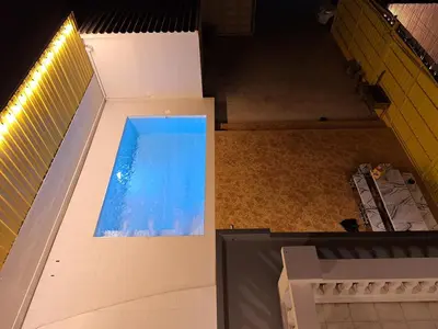 an overhead view of a swimming pool in a building at The Yellow House Poolvilla in Sathani Ban Hua Mak
