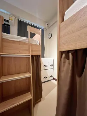 a small room with two bunk beds in a room at smoking buddy house in Bangkok