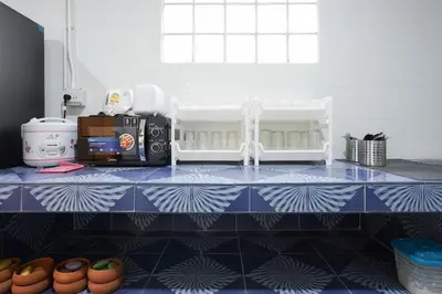 a kitchen with a blue and white counter top at Number 8 Poolvilla Bangkok in Sathani Ban Hua Mak