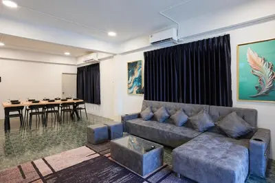 a living room with a couch and a table at Number 8 Poolvilla Bangkok in Sathani Ban Hua Mak