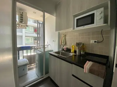 a small kitchen with a sink and a microwave at Stunning Condo - BTS On Nut - Pool, Gym, Wi-Fi in Bangkok