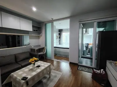 a living room with a couch and a table at Stunning Condo - BTS On Nut - Pool, Gym, Wi-Fi in Bangkok