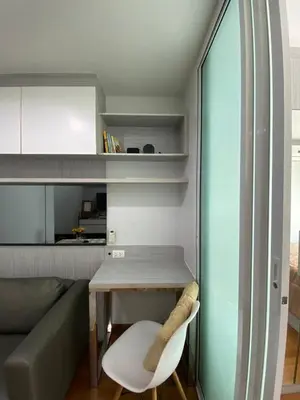 a living room with a table and a couch at Stunning Condo - BTS On Nut - Pool, Gym, Wi-Fi in Bangkok