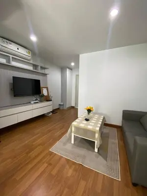 a living room with a couch and a table at Stunning Condo - BTS On Nut - Pool, Gym, Wi-Fi in Bangkok