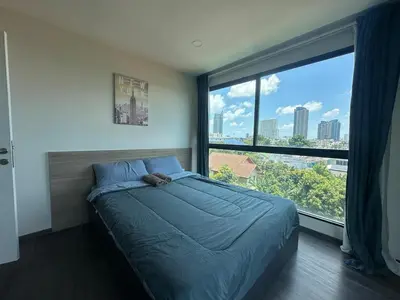 a bedroom with a bed and a large window at Chill Condo near Icon Siam in Bangkok