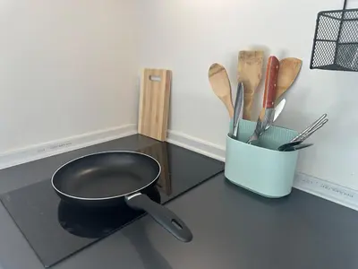 a kitchen counter with a pan and utensils at Chill Condo near Icon Siam in Bangkok