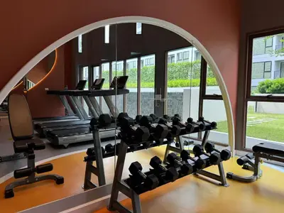 a fitness room with a gym with tread machines at Chill Condo near Icon Siam in Bangkok