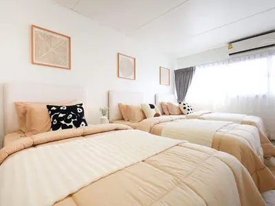 a bedroom with four beds in a room at 3 Beds,WiFi,Washing Machine,IMPACT Arena at T9 in Ban Bang Phang