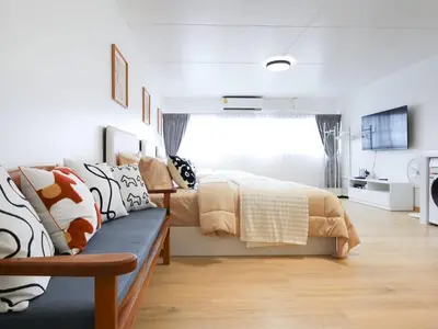 a bedroom with a bed and a couch at 3 Beds,WiFi,Washing Machine,IMPACT Arena at T9 in Ban Bang Phang