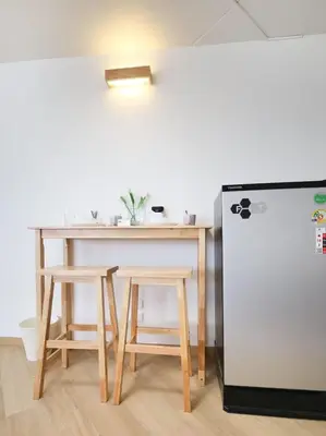 a table and two chairs and a refrigerator at 3 Beds,WiFi,Washing Machine,IMPACT Arena at T9 in Ban Bang Phang