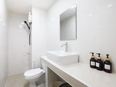 a white bathroom with a sink and a toilet at 3 Beds,WiFi,Washing Machine,IMPACT Arena at T9 in Ban Bang Phang