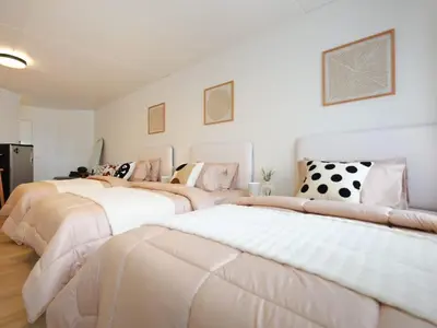 two beds in a room with white walls at 3 Beds,WiFi,Washing Machine,IMPACT Arena at T9 in Ban Bang Phang