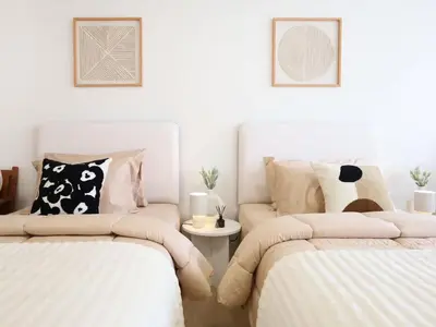 a bedroom with two beds and a couch at 3 Beds,WiFi,Washing Machine,IMPACT Arena at T9 in Ban Bang Phang