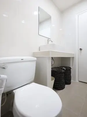 a white bathroom with a toilet and a sink at 3 Beds,WiFi,Washing Machine,IMPACT Arena at T9 in Ban Bang Phang
