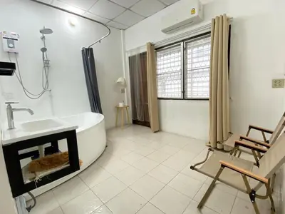 a bathroom with a bath tub and a sink at Cheap house 7min next to BTS Kasetsart , 5 bedroom in Ban Yang