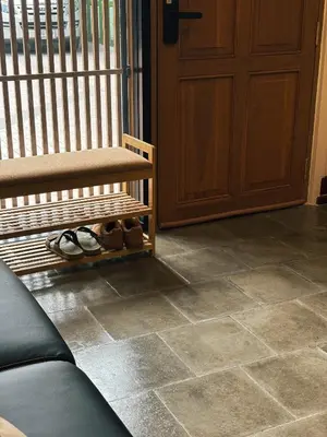 a room with a wooden door and a floor with shoes at SuXiang - Chinatown, Bangkok in Bangkok