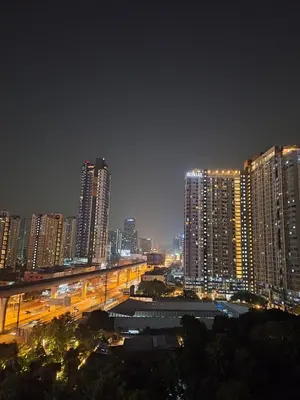 a city lit up at night with tall buildings at Mari's space city view in Nonthaburi