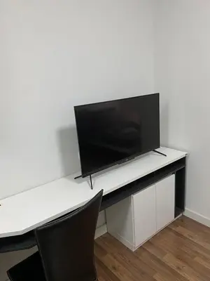 a white desk with a television on top of it at Mari's space city view in Nonthaburi