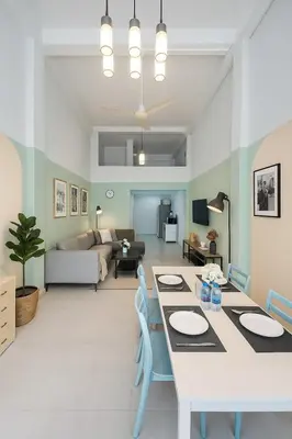 a dining room and living room with a table and chairs at GM5 - Cozy Apartment 8pax, Ladprao, MRT&BTS in Bangkok
