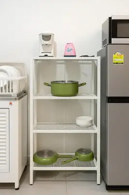 a white shelf with a pot and bowls on it at GM5 - Cozy Apartment 8pax, Ladprao, MRT&BTS in Bangkok