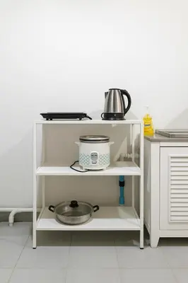 a white shelf with a pot and a bowl at GM5 - Cozy Apartment 8pax, Ladprao, MRT&BTS in Bangkok