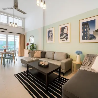 a living room with a couch and a table at GM5 - Cozy Apartment 8pax, Ladprao, MRT&BTS in Bangkok