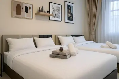 two beds sitting next to each other in a bedroom at GM5 - Cozy Apartment 8pax, Ladprao, MRT&BTS in Bangkok
