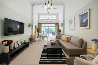 a living room with a couch and a tv at GM5 - Cozy Apartment 8pax, Ladprao, MRT&BTS in Bangkok