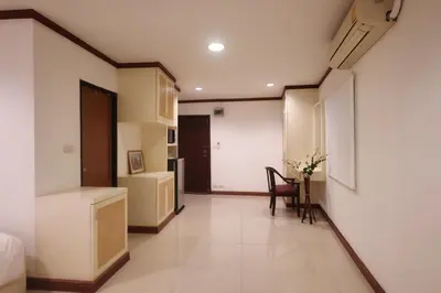 a room with a bed and a desk and a chair at Sampheng House in Bangkok