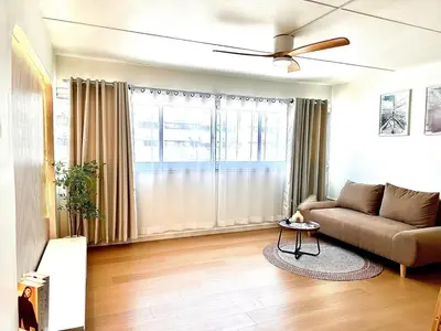 a living room with a couch and a ceiling fan at CinCin Popular Condo in Thung Si Kan