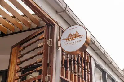 a sign on the side of a building at Baan Manee BKK in Bangkok