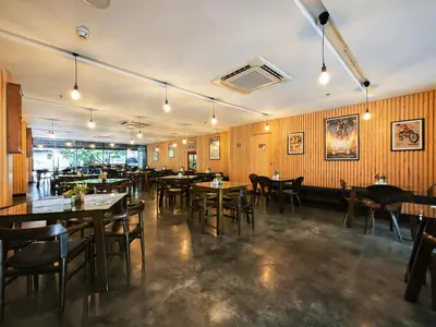 a restaurant with wooden walls and tables and chairs at Galleria 12 Sukhumvit Bangkok by Compass Hospitality in Bangkok