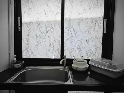 a kitchen counter with a sink and a window at Irich Residence Theparak S209 BTS-Chang Erawan 2kms in Ban Khlong Hua Sakae