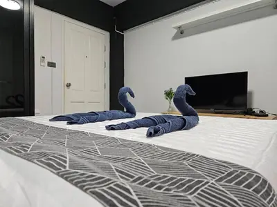 three blue snakes laying on top of a bed at Irich Residence Theparak S209 BTS-Chang Erawan 2kms in Ban Khlong Hua Sakae