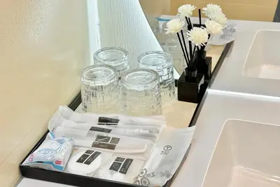a drawer in a bathroom with glasses and a sink at Happy house in Bangkok