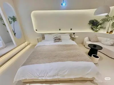 a bedroom with a large bed in a white room at Happy house in Bangkok