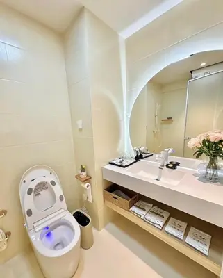 a bathroom with a toilet and a sink at Happy house in Bangkok
