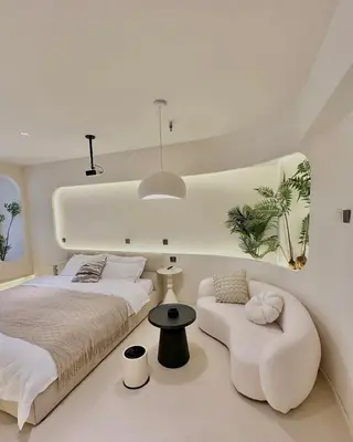 a white bedroom with a bed and a chair at Happy house in Bangkok