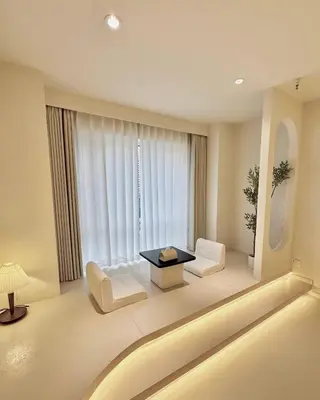 a living room with white furniture and a large window at Happy house in Bangkok
